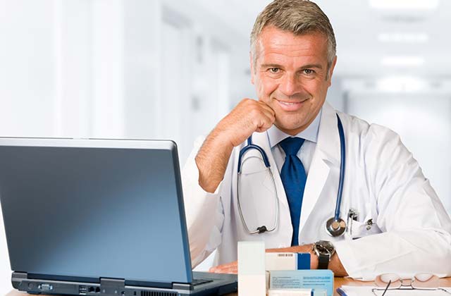 Online doctor working in his computer